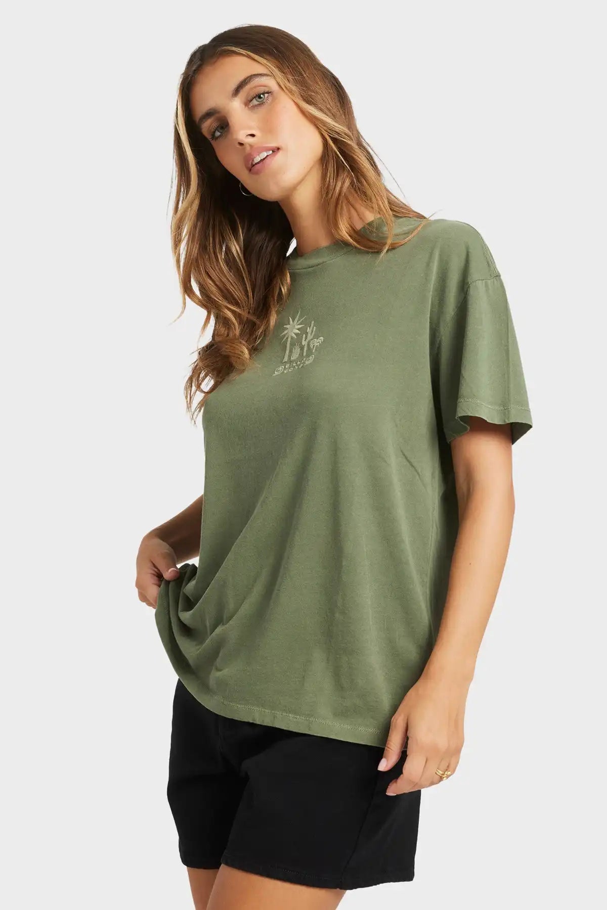 Woman wearing an Billabong olive green t-shirt with a small logo on a white background