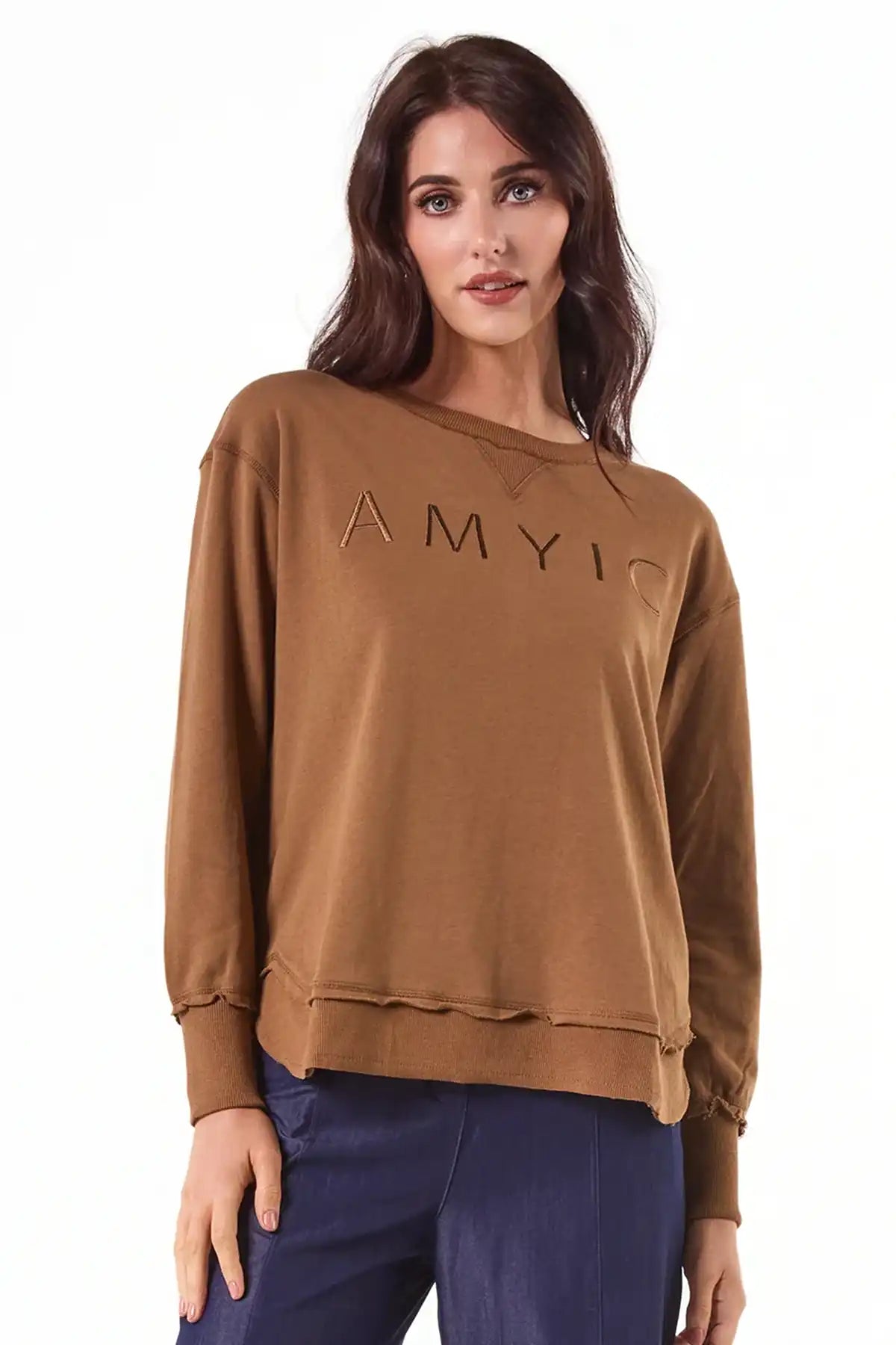 Woman wearingChille Everyday Wander Pullover in Mocha with embroidery on front against a white background