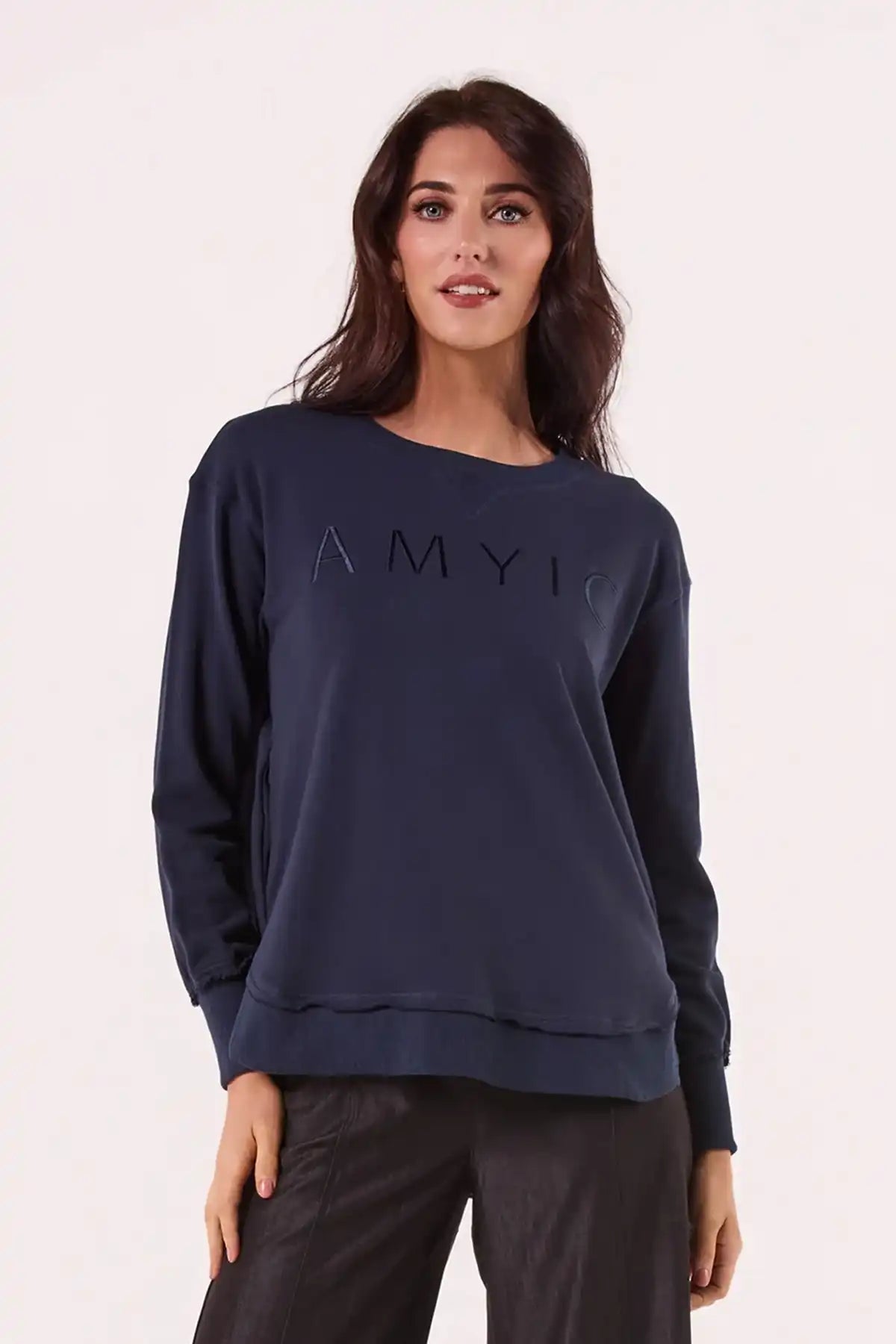 Woman wearing a Chille Everyday Wander Pullover in Navy with 'AMYI' logo on a white background front view