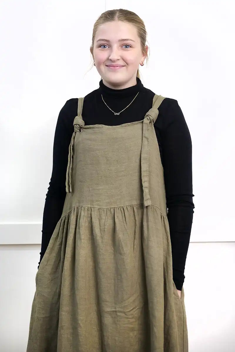 Chille Merino Whisper Top in black under a olive pinafore dress
