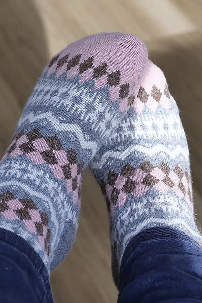 Patterned socks worn on a neutral background