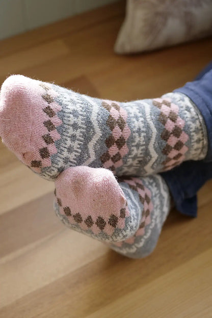 Pair of patterned socks on a wooden floor