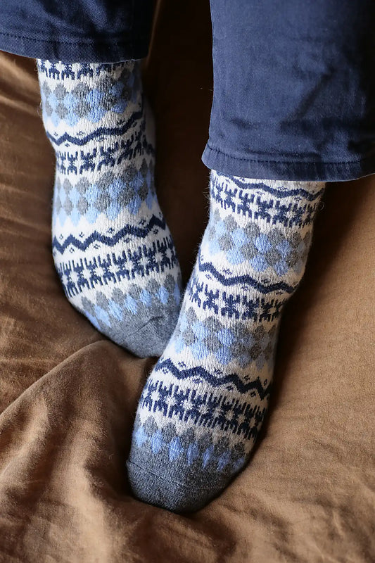 Patterned socks worn on a brown surface