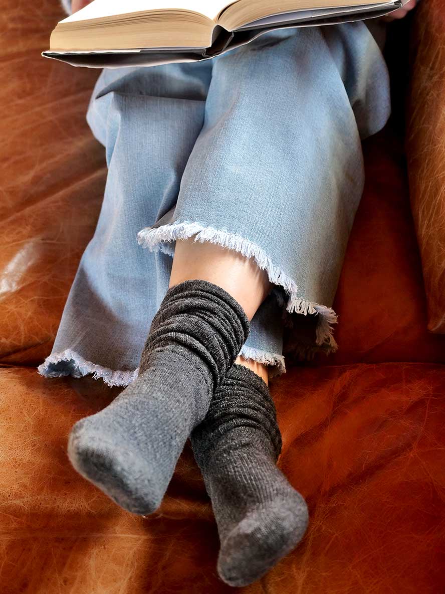 model on coach with book Chille Wool Blend Socks in Charcoal