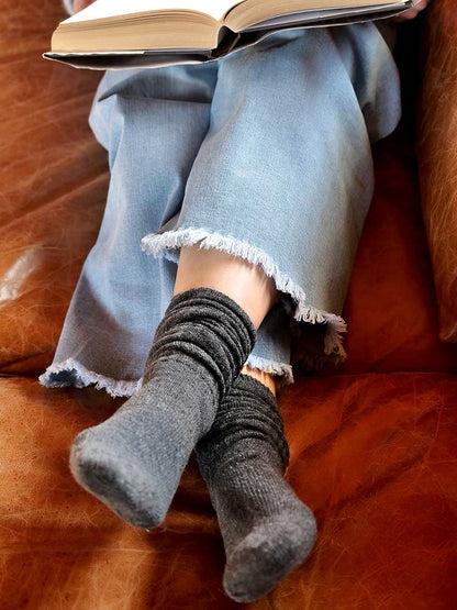 model on coach with book Chille Wool Blend Socks in Charcoal