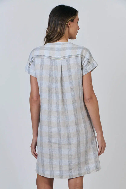 Woman wearing a Coastal Drift Linen Dress in Mesh against a plain background back view