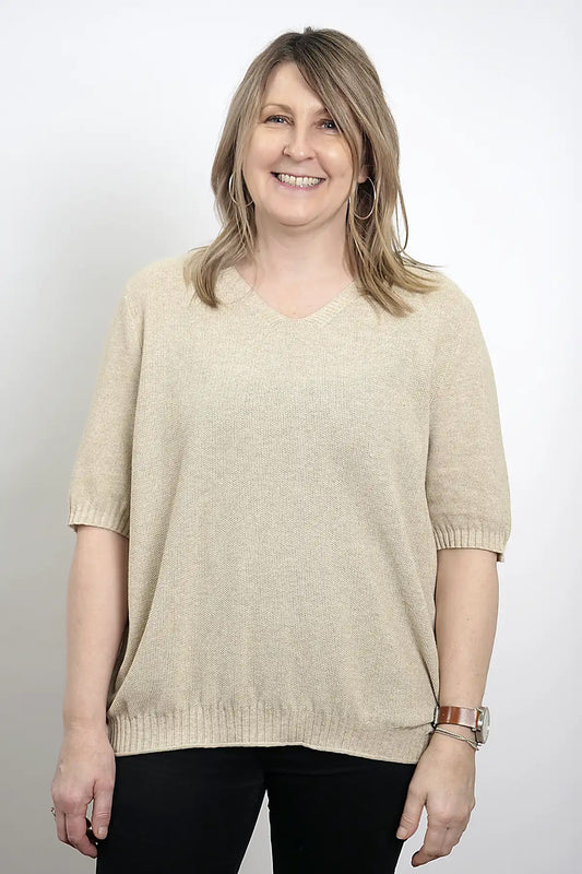 Woman wearing a Coastal Ease Cotton Knit Tee in Sand against a plain background