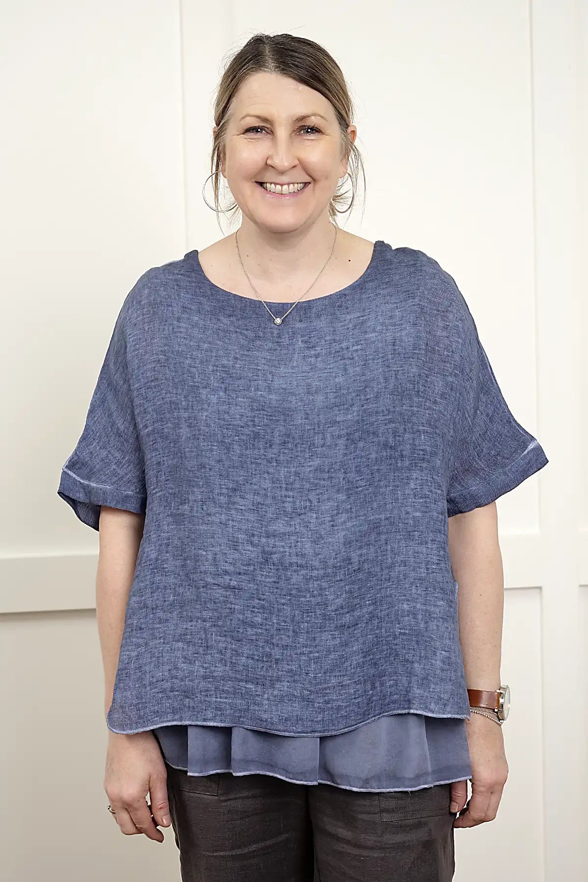 Woman wearing a Elena Linen Top in Denim in Denim with a white background