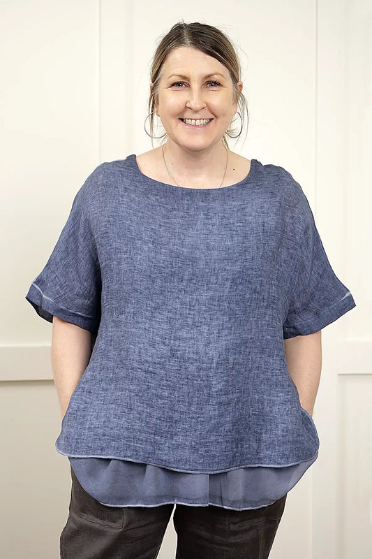 Woman wearing a Elena Linen Top in Denim against a white background