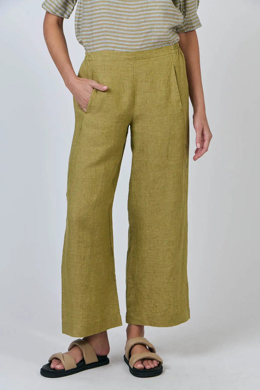 Person wearing Elysian Linen Pant in Bamboo Green on a white background front detail showing front pocket