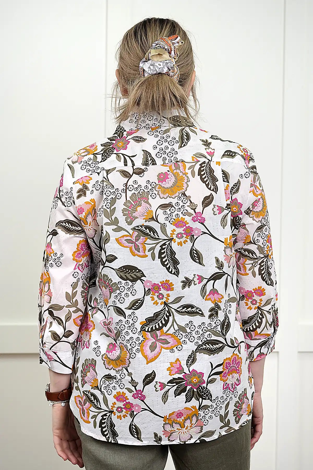 Person wearing a Flora Cotton Floral Shirt from behind against a white background