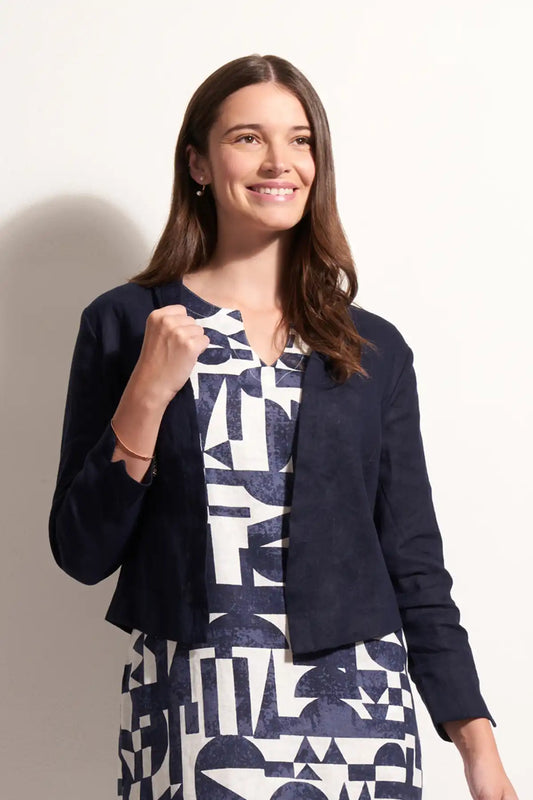 Woman wearing a Foil Linen Gather Together Jacket in True Navy over a patterned dress against a plain background