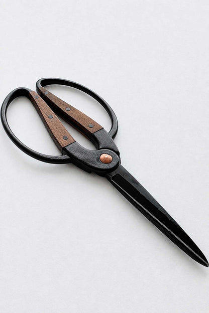 A pair of pruning scissors with black metal blades and handles, featuring brown wooden inlays and a copper-colored center rivet, shown on a light gray background.