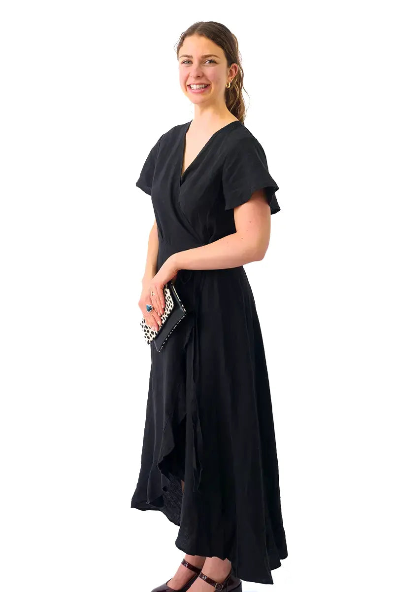 side view of the Humidity  Kai Linen Wrap Dress in Black