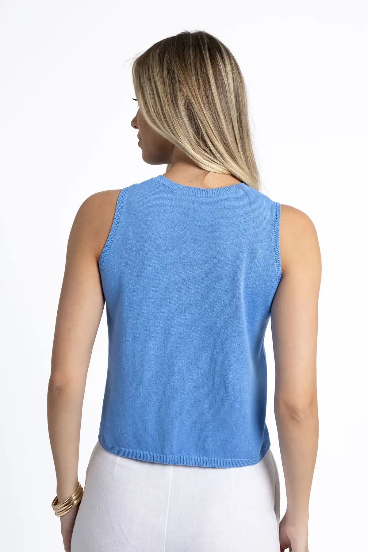 Woman wearing a Humidity Collette Tank in Cornflower Blue from behind on a white background