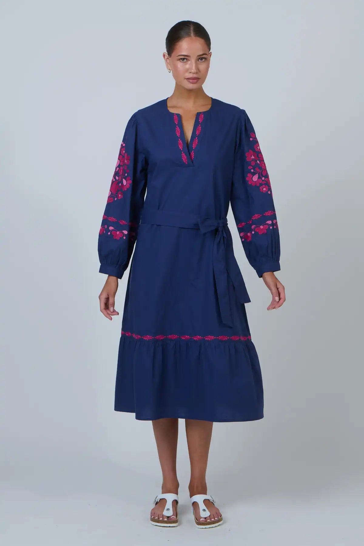 woman wearing Ink Rose Embroidered Midi Dress and white sandals against a white background