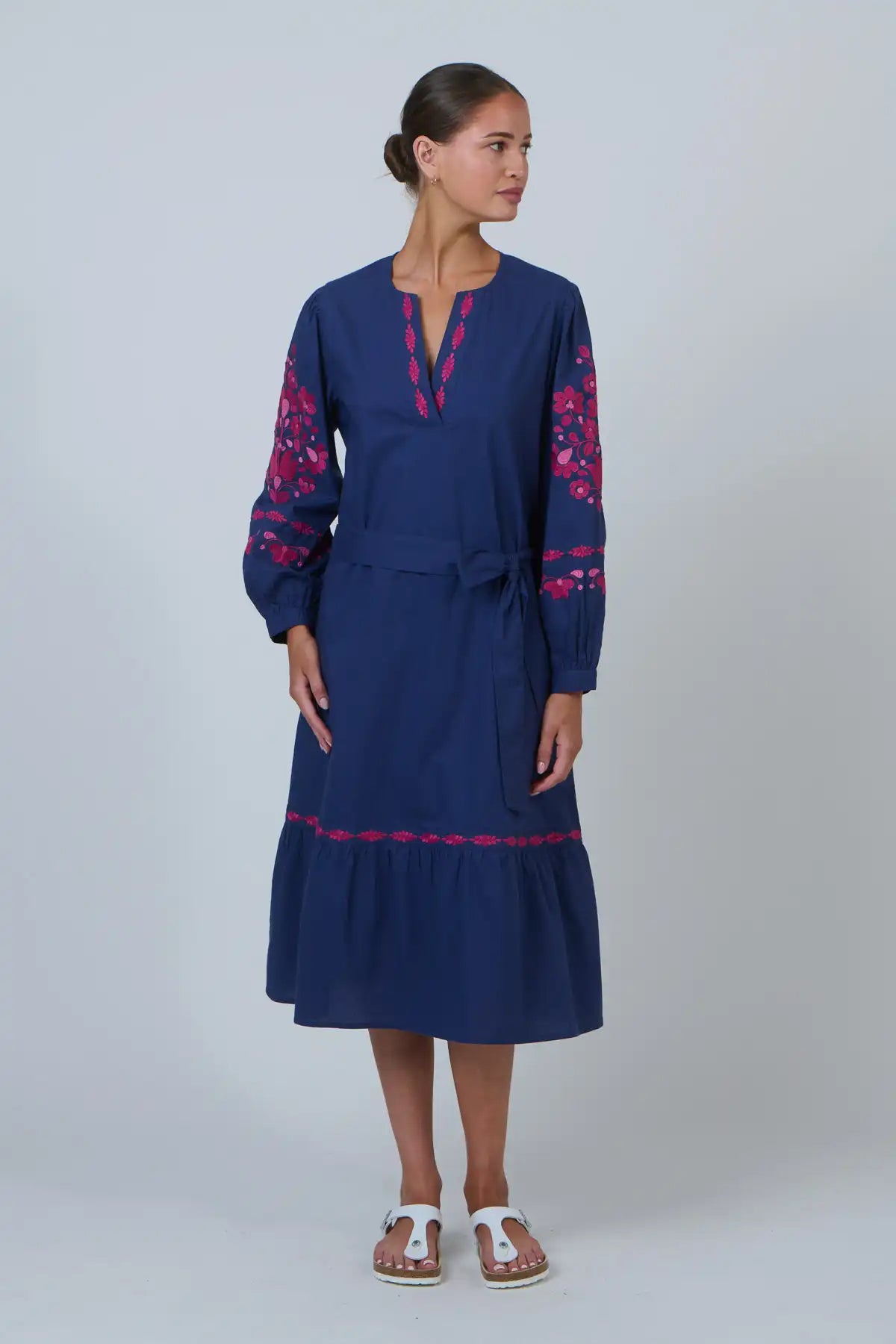 woman wearing Ink Rose Embroidered Midi Dress and white sandals against a white background