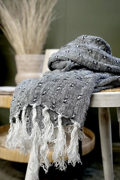 Le Quai Linen Scarf – Hand-Loomed in Monochrome draped over the side table