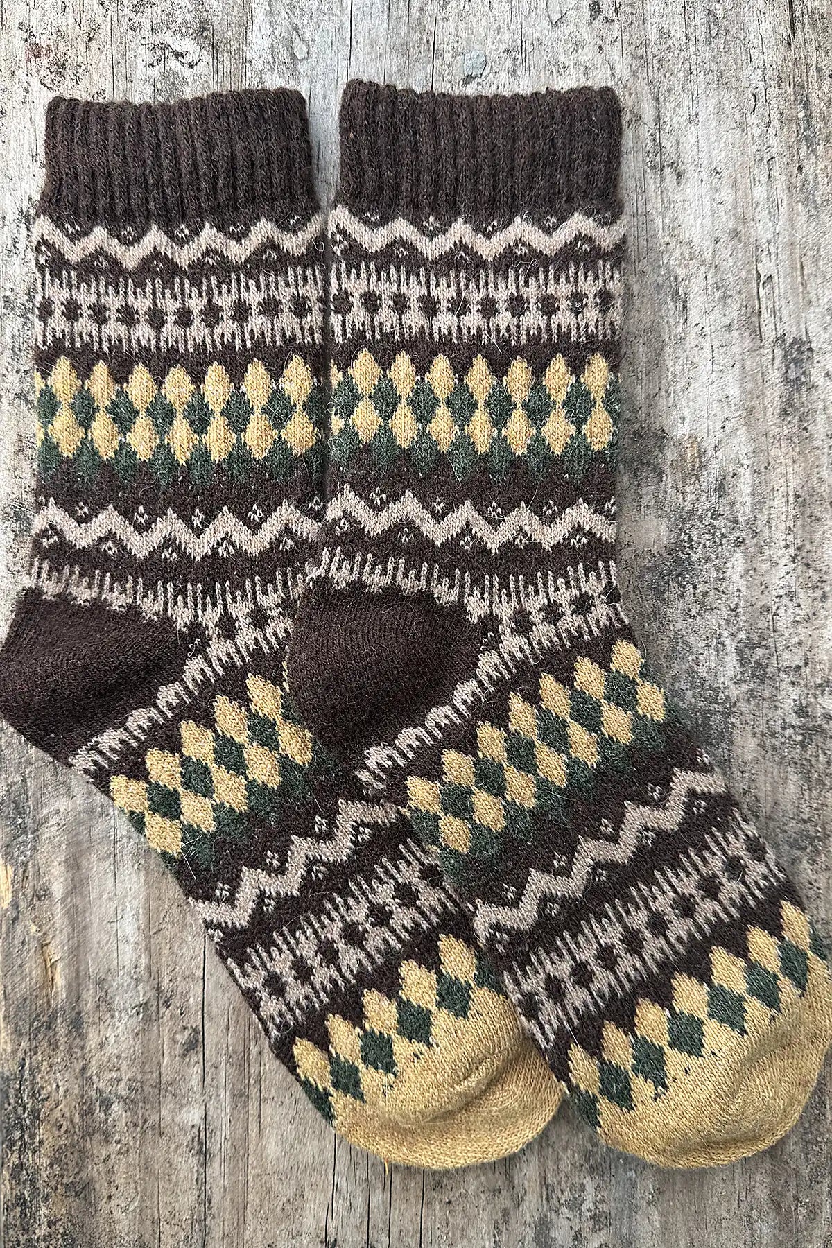 Pair of patterned socks on a wooden surface