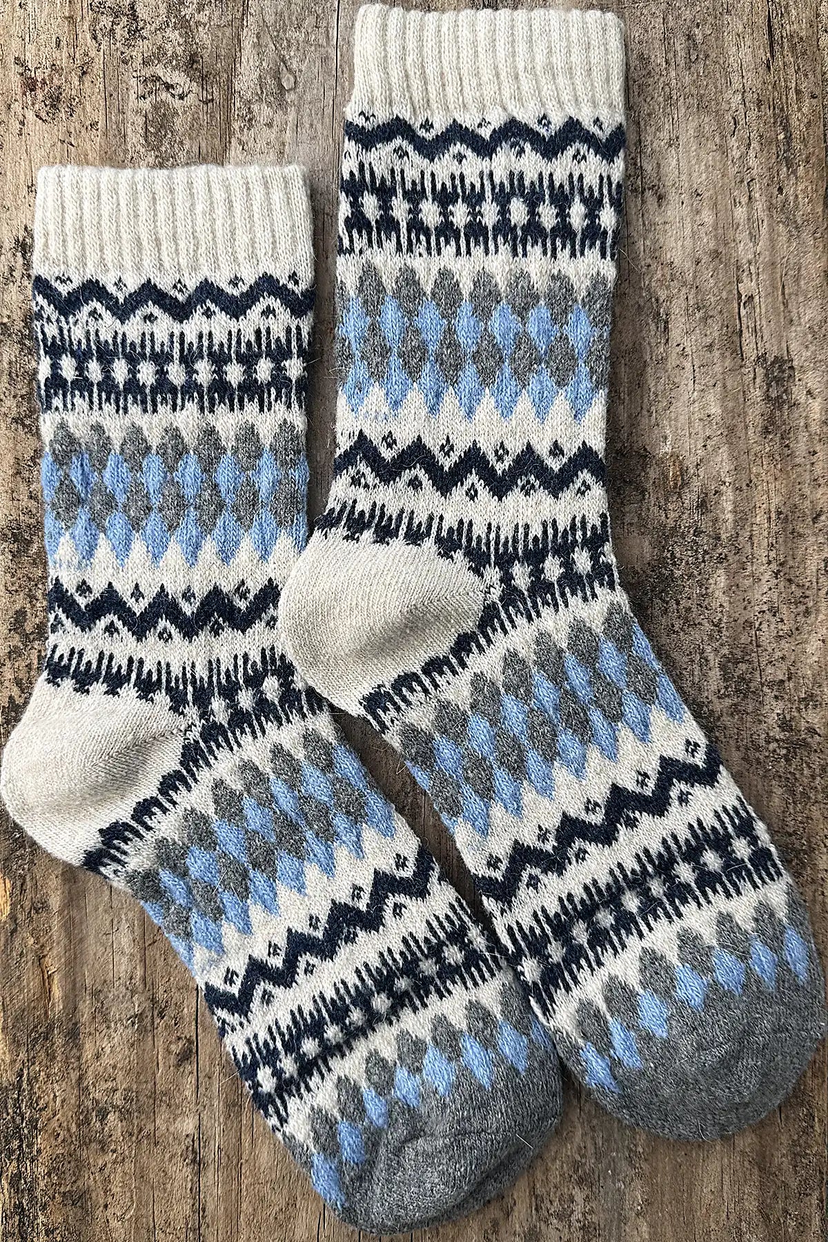 Pair of patterned socks on a wooden surface