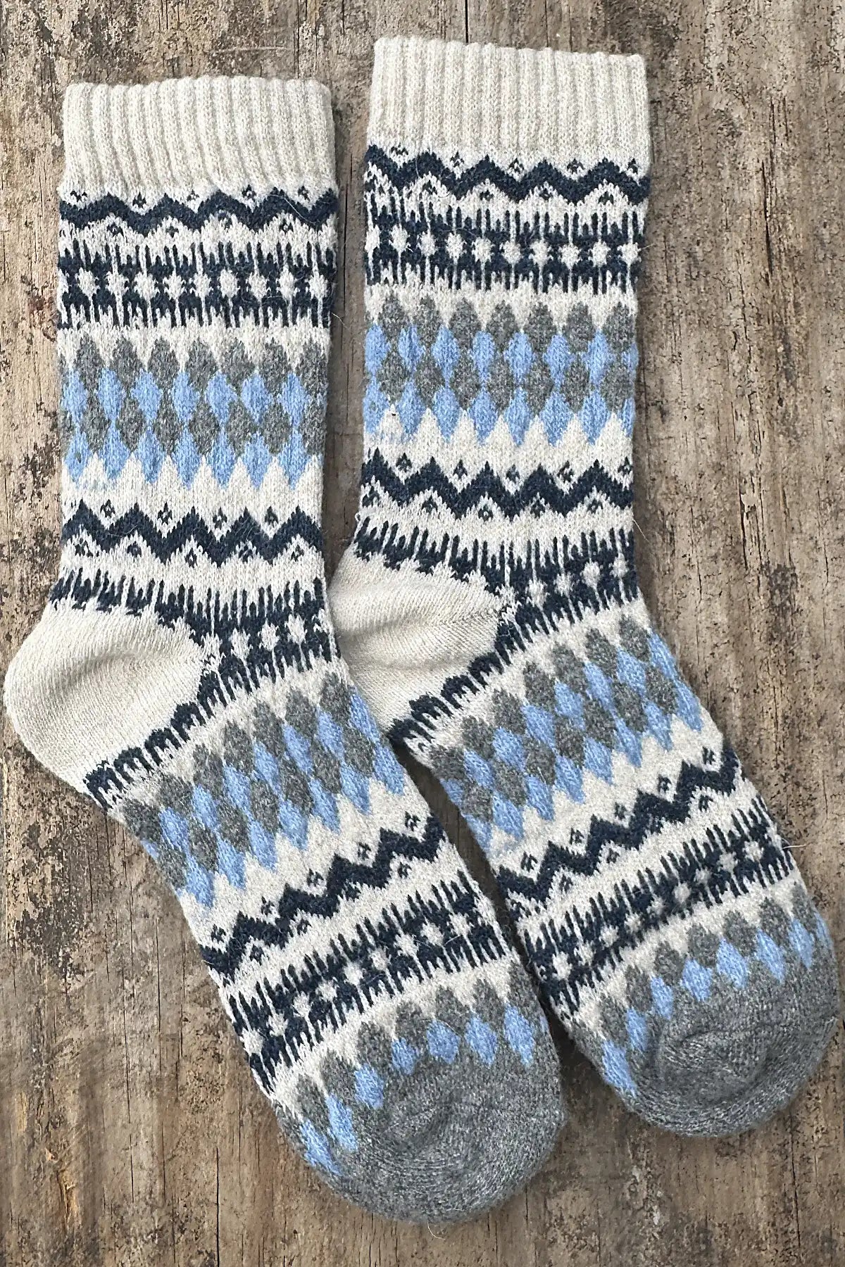 Pair of patterned socks on a wooden surface