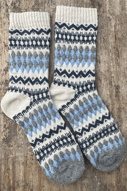 Pair of patterned socks on a wooden surface