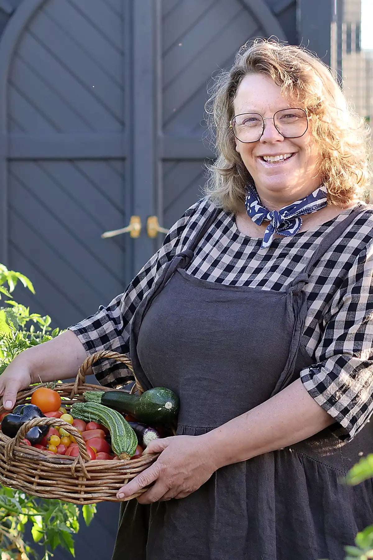 Woman holding a basket of vegetables outdoors