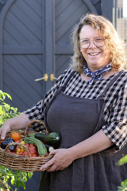 Woman holding a basket of vegetables outdoors
