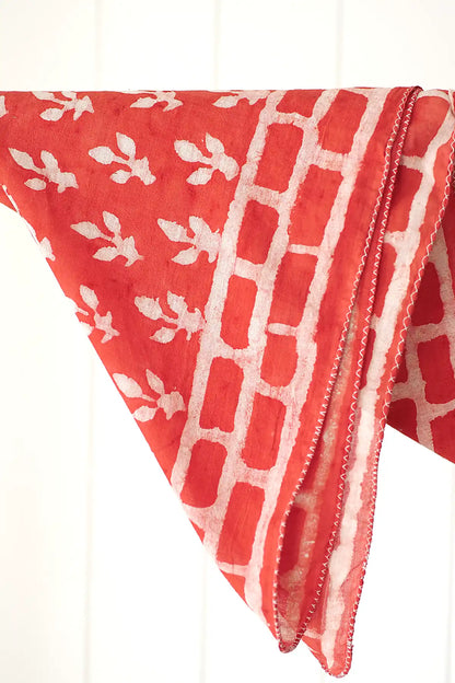 Red fabric neckerchief with white patterns on a white background