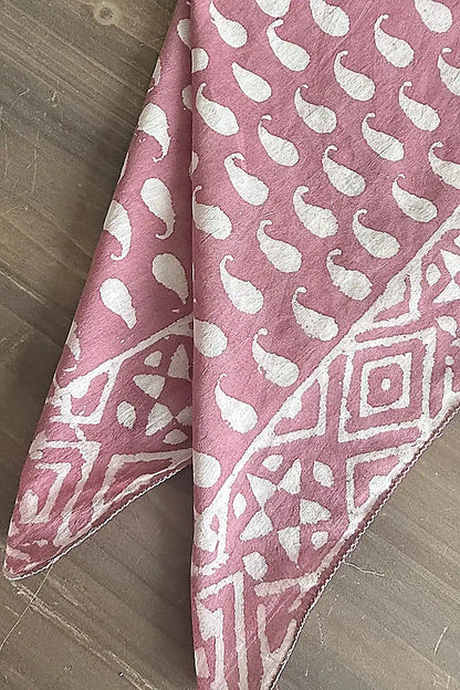 pink cotton fabric scarf with a white patten on a wooden table
