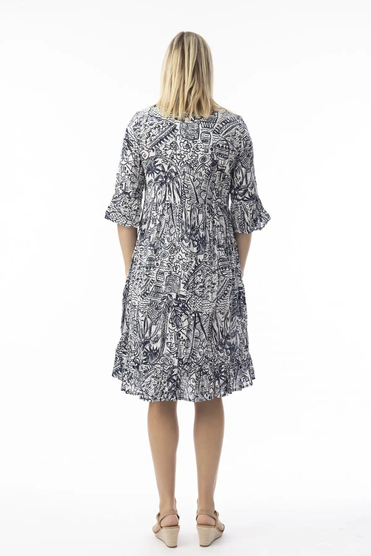 Woman wearing a  Orientique Aksharay Navy Dress from behinda against a white background