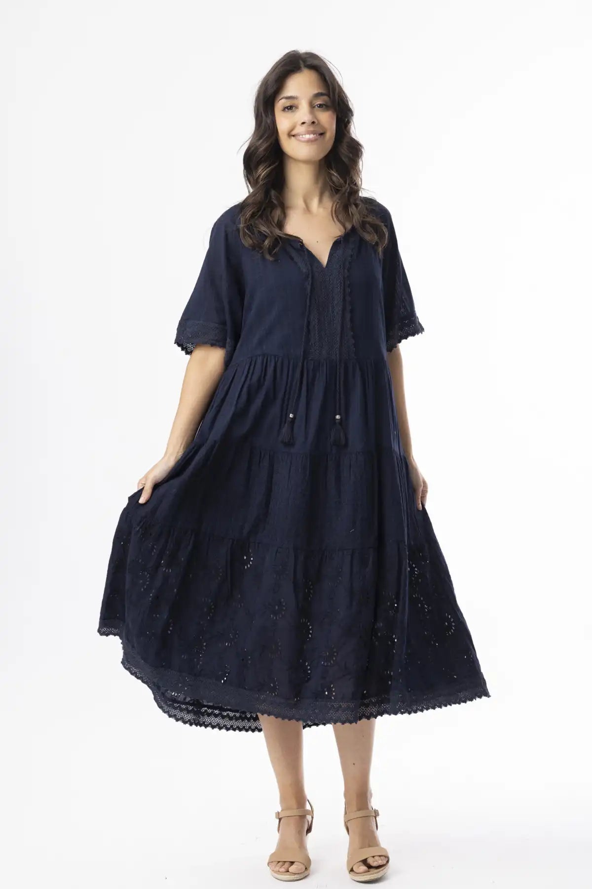 Woman wearing a navy blue dress on a white background