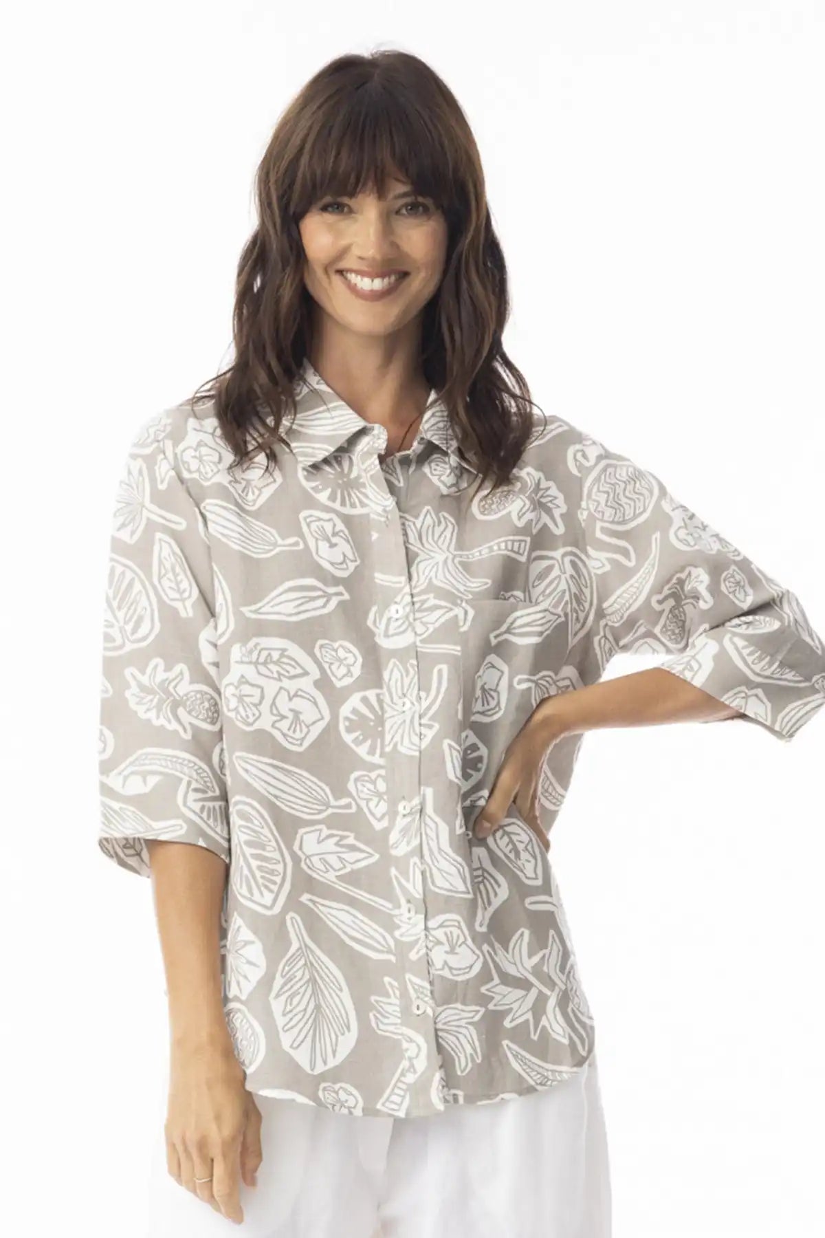Woman wearing a Orientique Escape Linen Boxy Collar Shirt in sand print on a white background