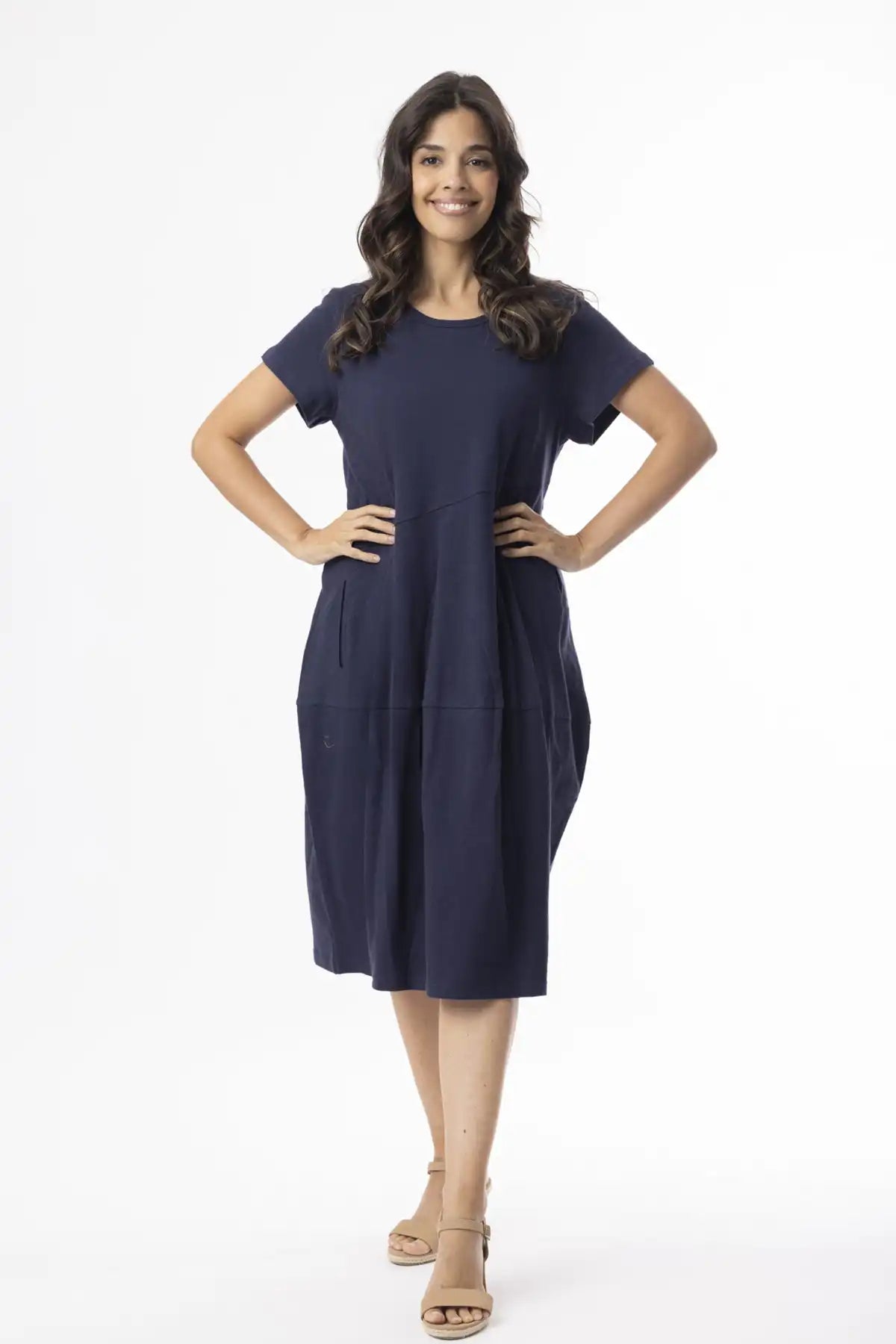 Woman wearing a Orientique Essentials Organic Cotton Bubble Dress – Navy on a white background