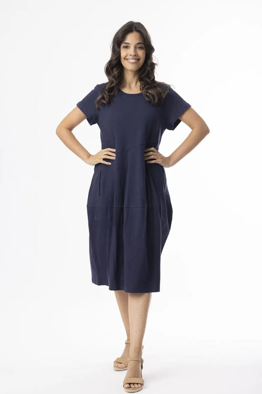 Woman wearing a Orientique Essentials Organic Cotton Bubble Dress – Navy on a white background