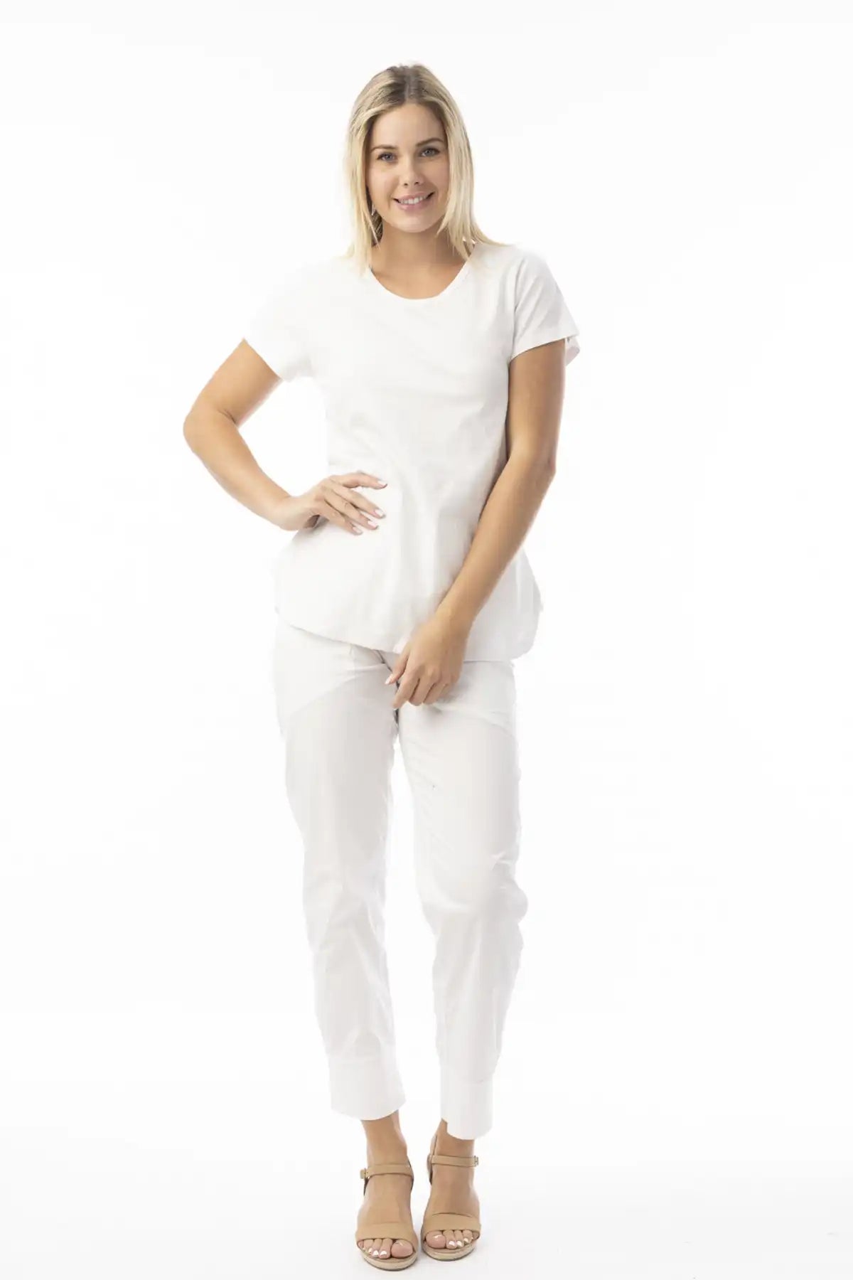 Woman wearing a Orientique Essentials Organic Cotton Crew Tee in White full model view on a white background