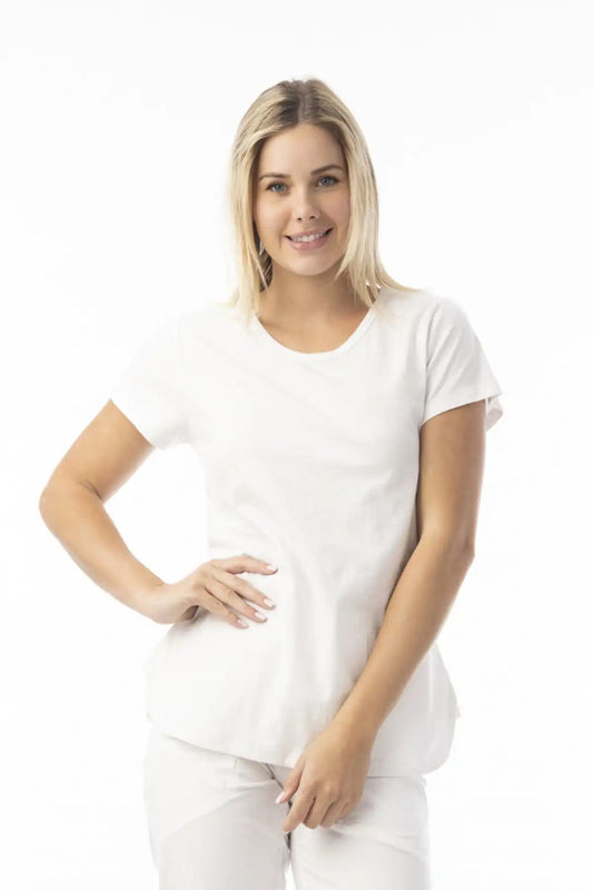 Woman wearing a Orientique Essentials Organic Cotton Crew Tee in White and pants on a white background