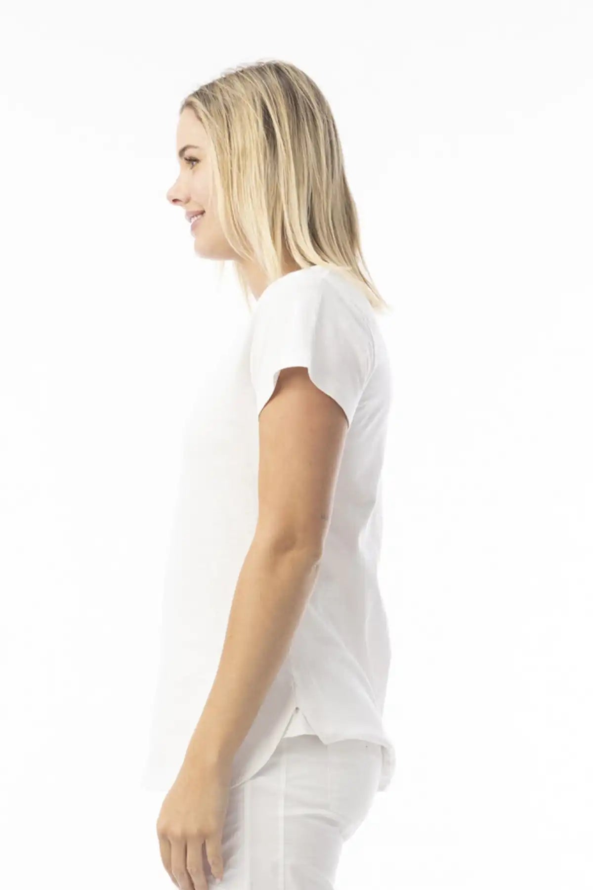 Woman wearing a Orientique Essentials Organic Cotton Crew Tee in White side view on a white background
