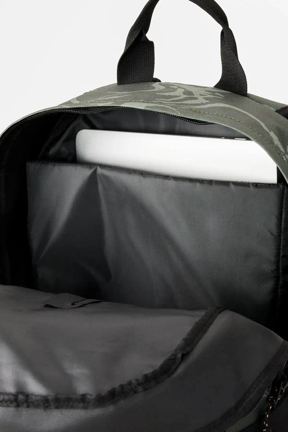 Rip Curl Backpack with a roll of paper inside, on a light gray background