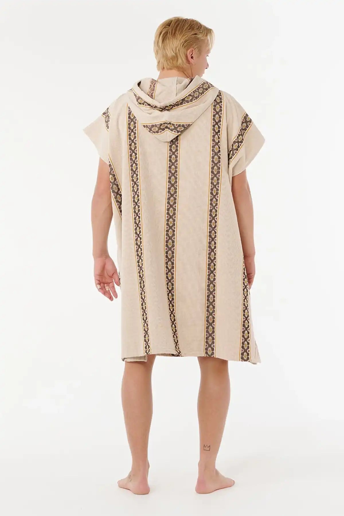 Person wearing a beige hooded towel with black patterns on a white background