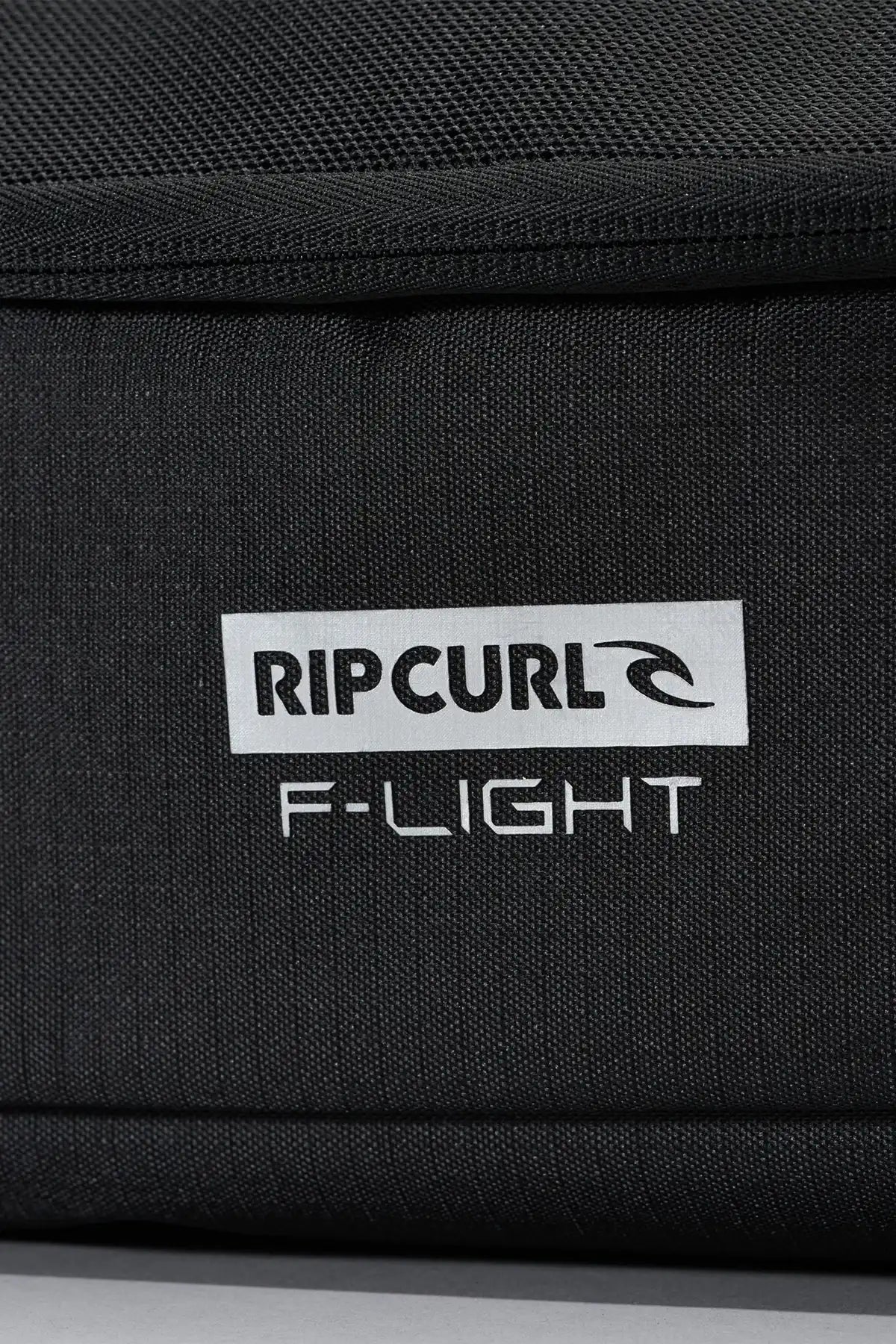 Black bag with Rip Curl logo and 'F-Light' text on a close-up view