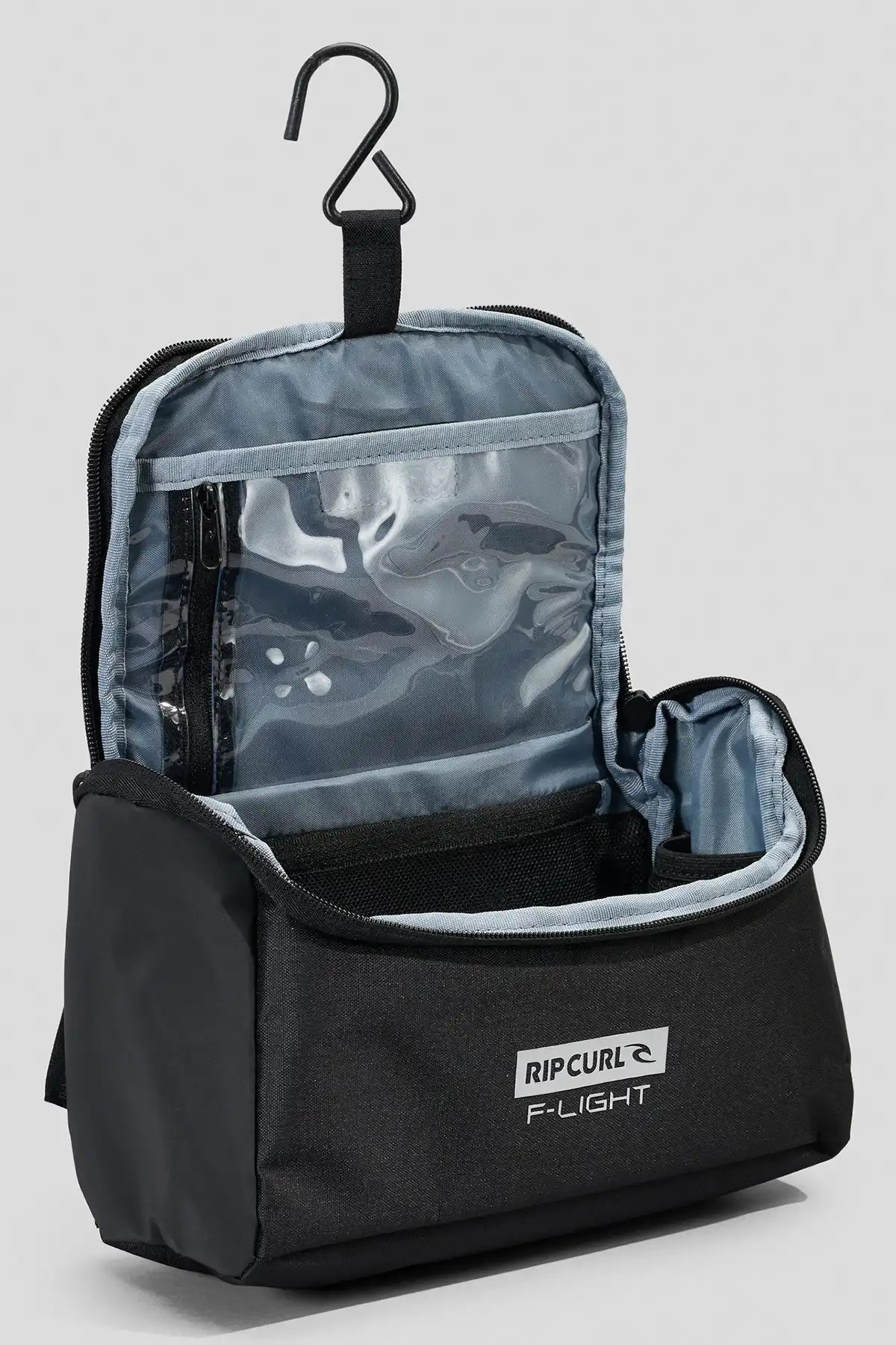Black Rip Curl F-Light Icons toiletry bag with clear compartment and hanger on a light gray background