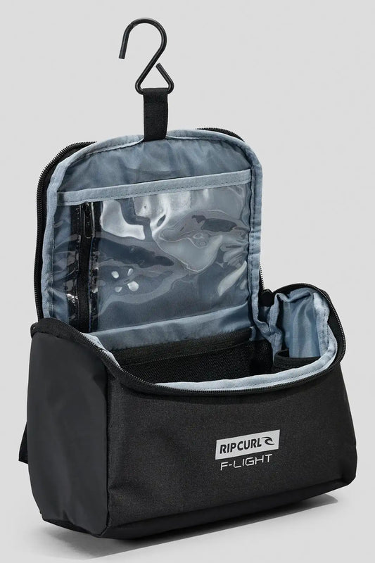 Black Rip Curl F-Light Icons toiletry bag with clear compartment and hanger on a light gray background