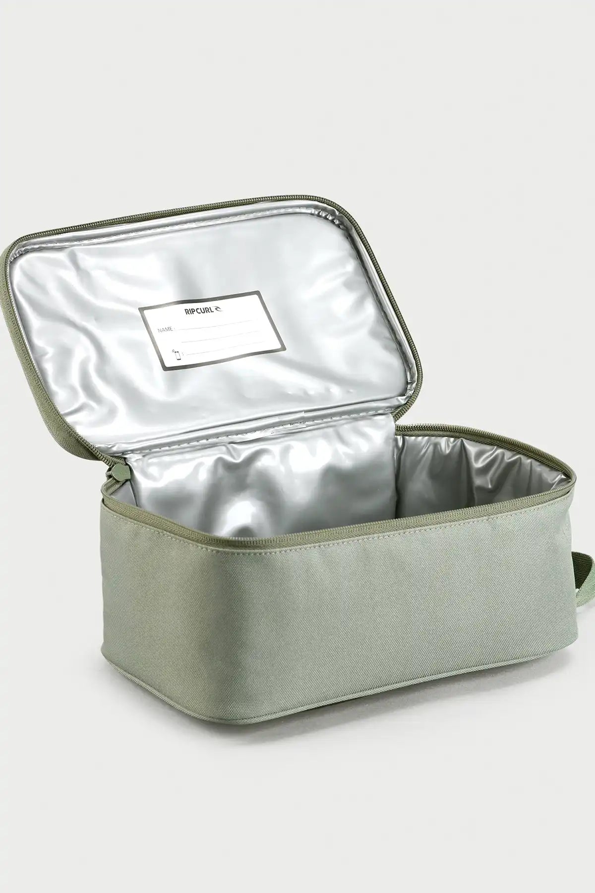 Rip Curl Sea Spray Green insulated lunch bag with a white label on a light gray background