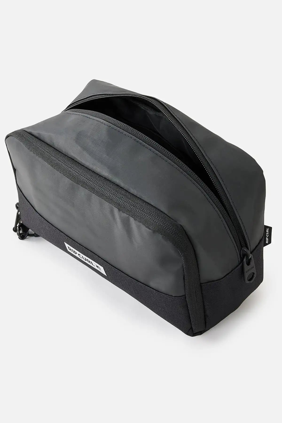 Black toiletry bag with a visible Rip Curl brand label on a white background