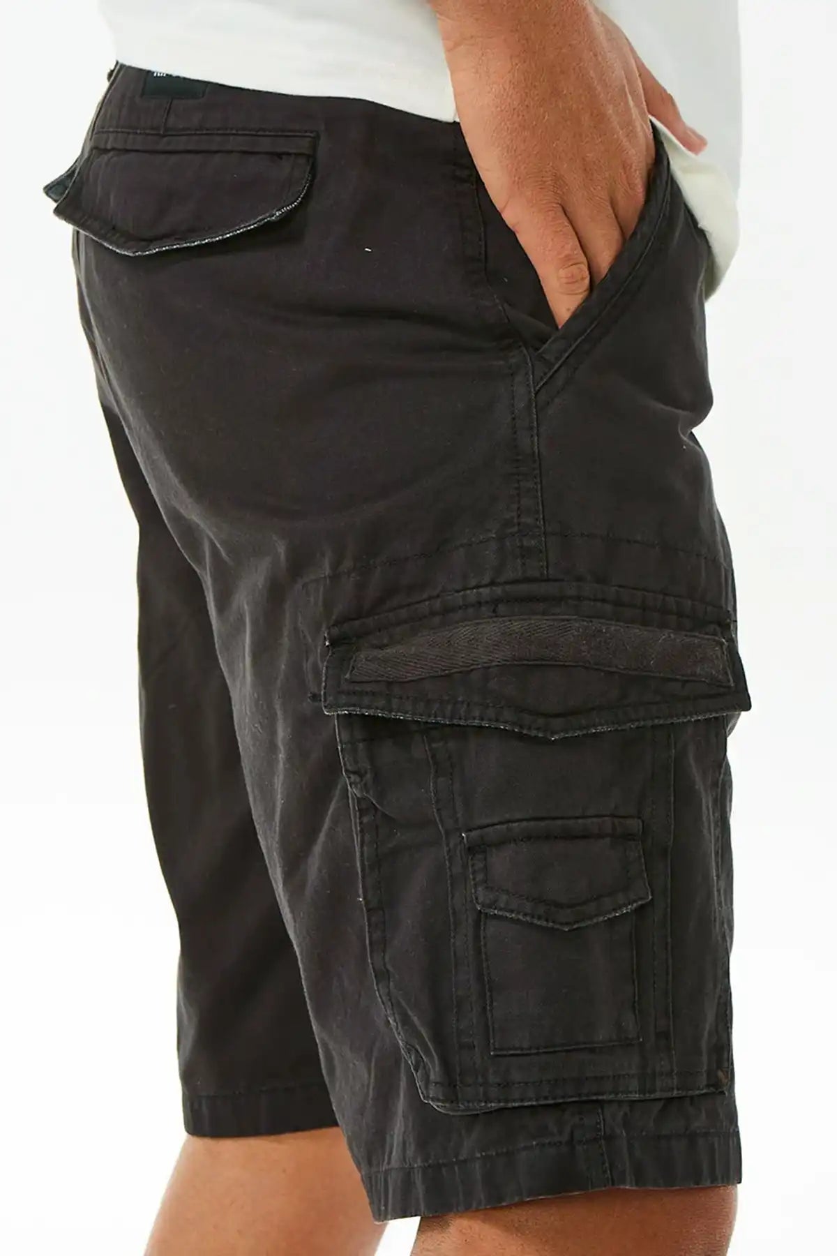 Rip Curl Washed Black cargo shorts worn by a person on a white background