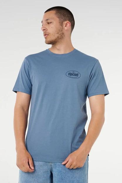 Man wearing a blue t-shirt with a Rip Curl logo on a white background
