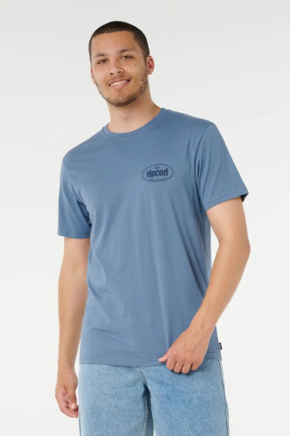 Man wearing a blue t-shirt with a Rip Curl Logo on a white background