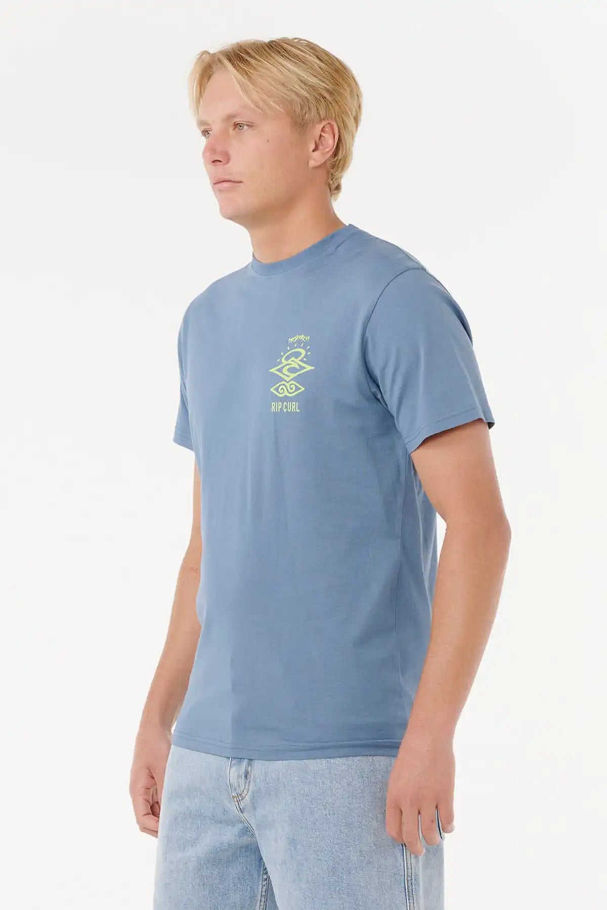 Man wearing a Rip Curl Mens Search Icon Tee in Blue Fin with a green logo on a white background side view