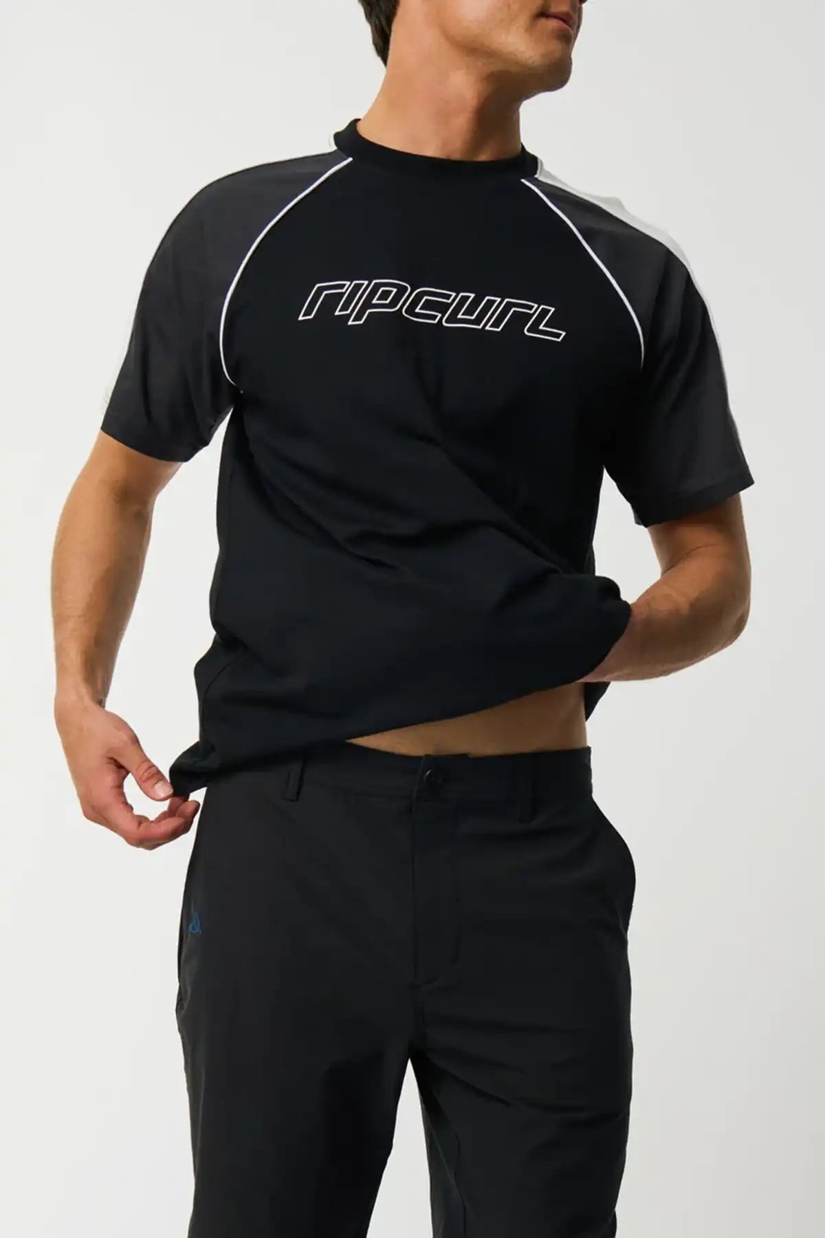 Person wearing a black Rip Curl shirt on a white background and Rip Curl Mens Shorts Phase Nineteen 19" Boardwalk - Black